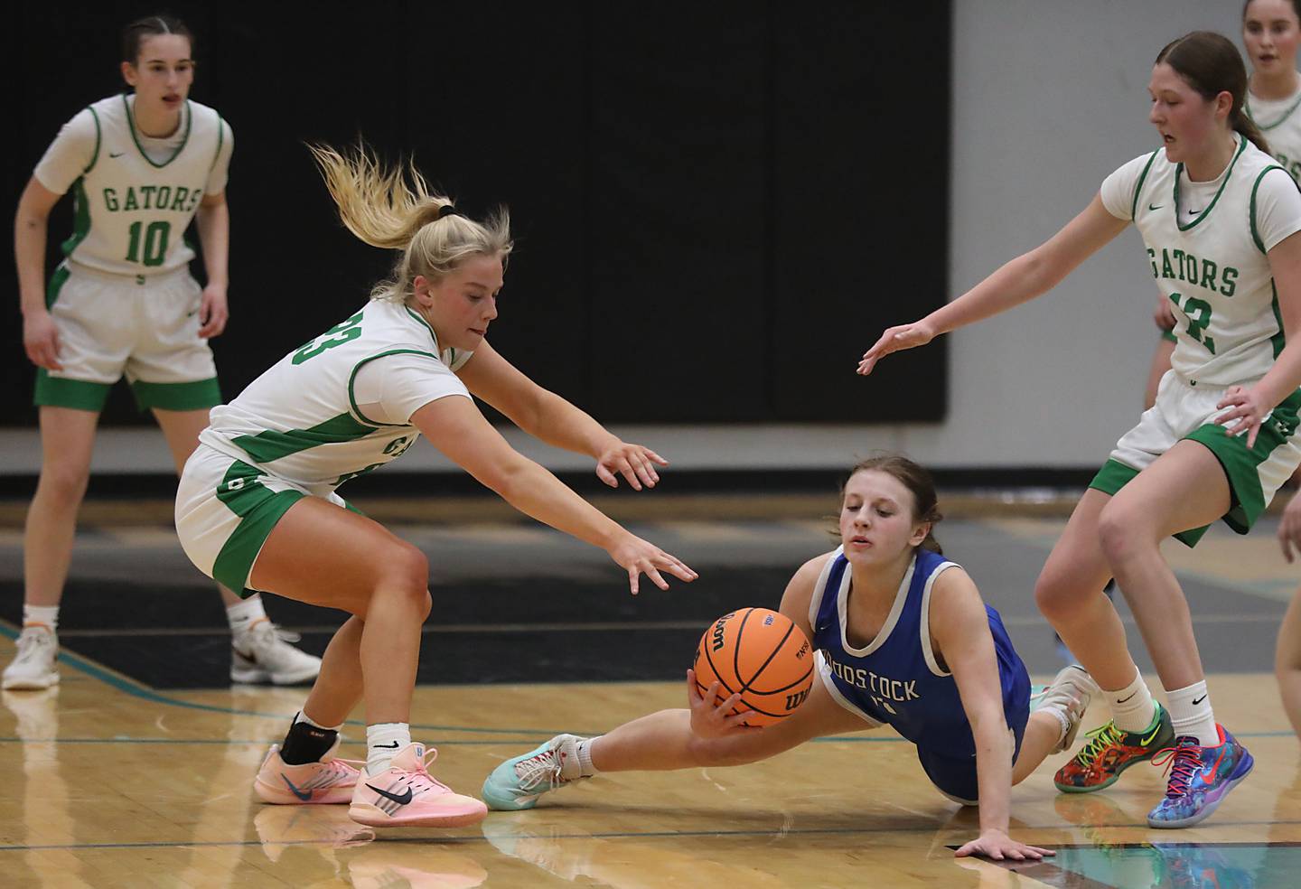 Woodstock's Emma Douglas tries to control the ball in between Crystal Lake South's Laken LePage (left) and Crystal Lake South's Gaby Dzik (right) during the IHSA Class 3A Woodstock North Regional championship girls basketball game on Thursday, Feb. 19, 2026, at Woodstock North High School.