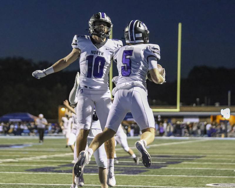Downers Grove North's Maxwell Troha (5) celebrates a touchdown catch and run with Oliver Thulin (10) during football game between Downers Grove North at Downers Grove South Friday, Sept 5, 2025 in Downers Grove.