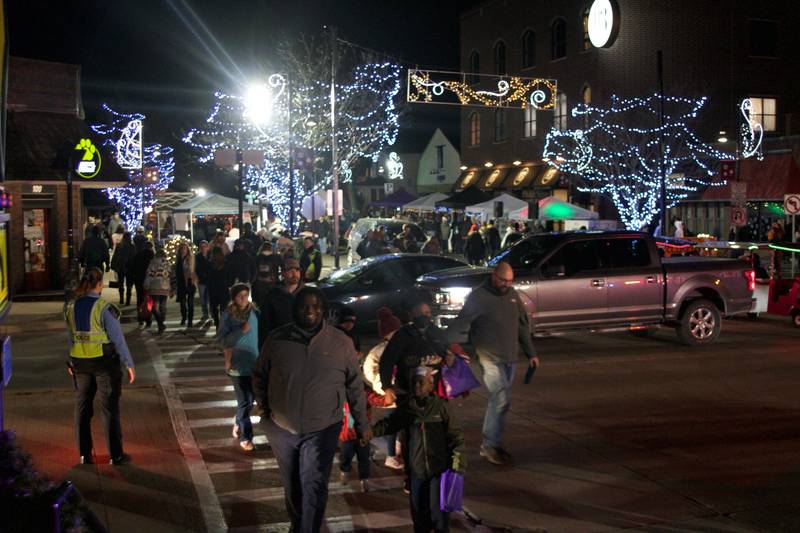 Officers from the Oswego Police Department helped Christmas Walk patrons cross from one side of Main Street to the other on Dec. 3.