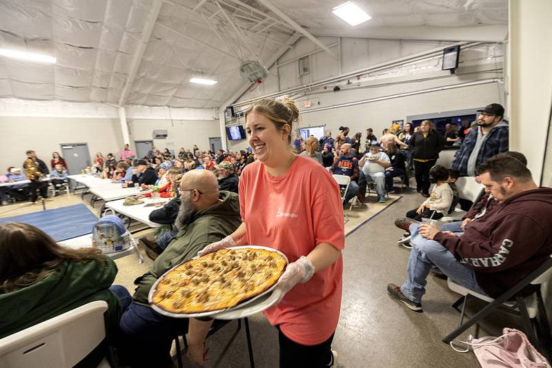 Pizza is delivered ringside with a smile at The Classroom.