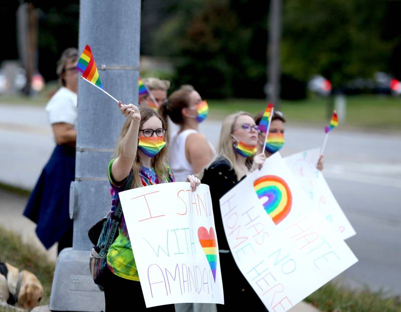 Benet Academy parents, alumni and supporters demonstrate outside the Lisle Catholic school in response to administrators rescinding an employment offer to the new girls lacrosse coach after learning that she was gay. The school reportedly hired Amanda Kammes, a Benet alum and head girls varsity lacrosse coach at Montini Catholic High School in Lombard, but rescinded the offer when her paperwork included her wife’s name as her emergency contact.