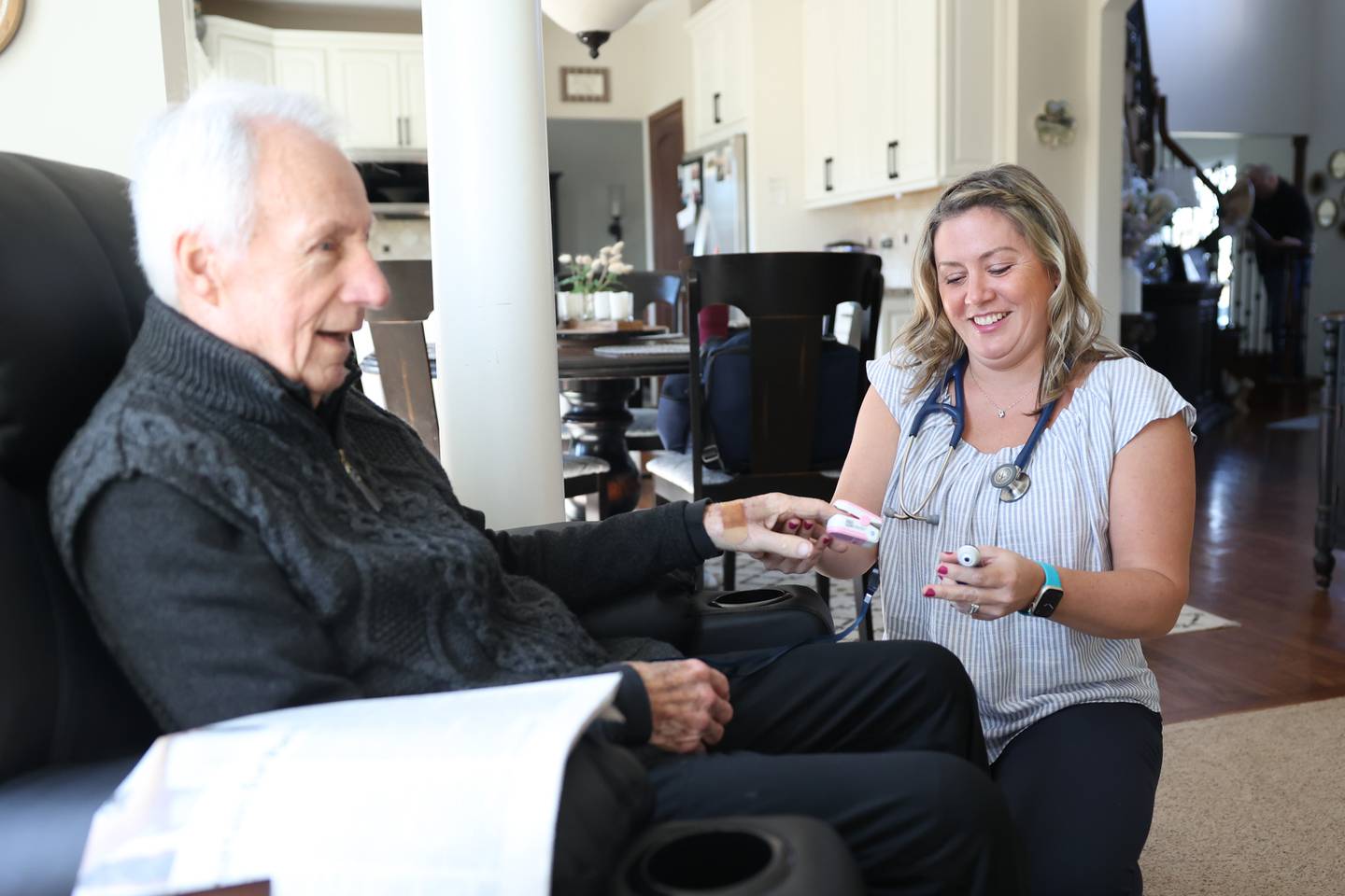 Nicole Hartley, lead nurse practitioner for Lightways’ serious illness care program, checks the vitals of Bob Jolly at his home on Wednesday March 6, 2024, in Lemont.