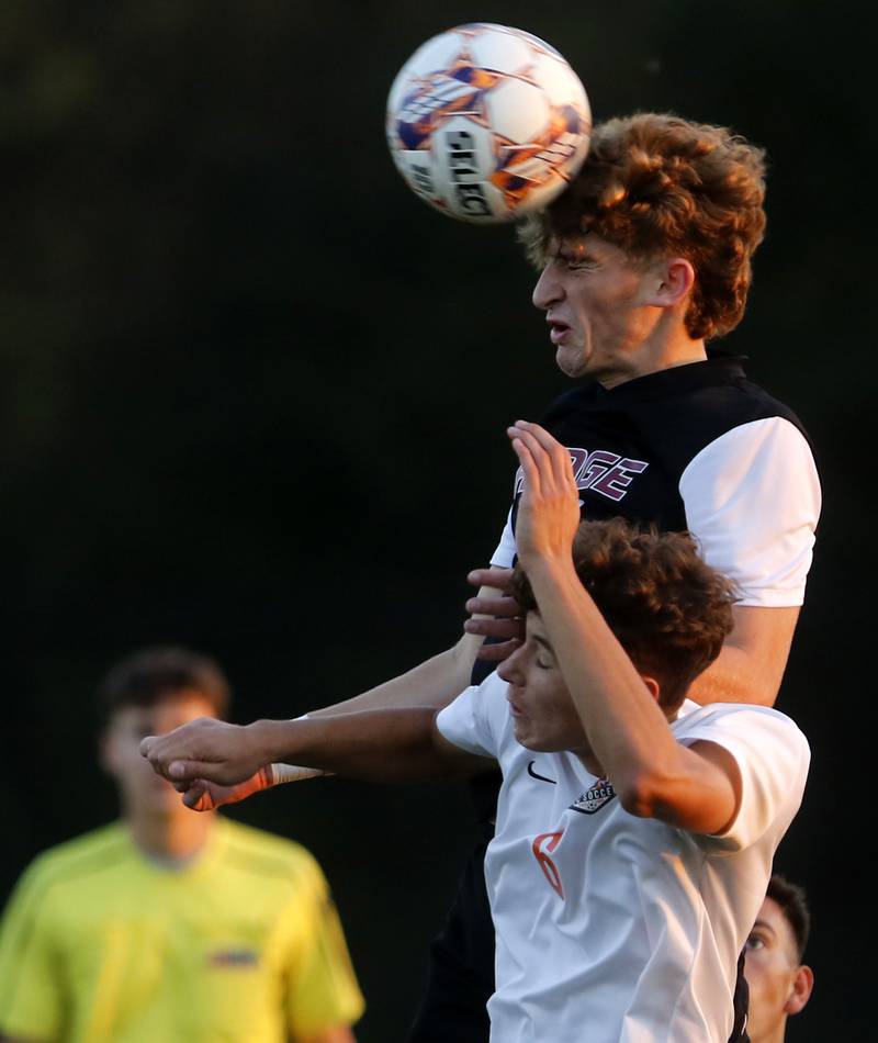 Prairie Ridge's Chase Santucci heads the ball towards the goal over Crystal Lake Central's Nick Pagonis during a Fox Valley Conference soccer match on Thursday, Oct. 10, 2024, at Prairie Ridge High School.