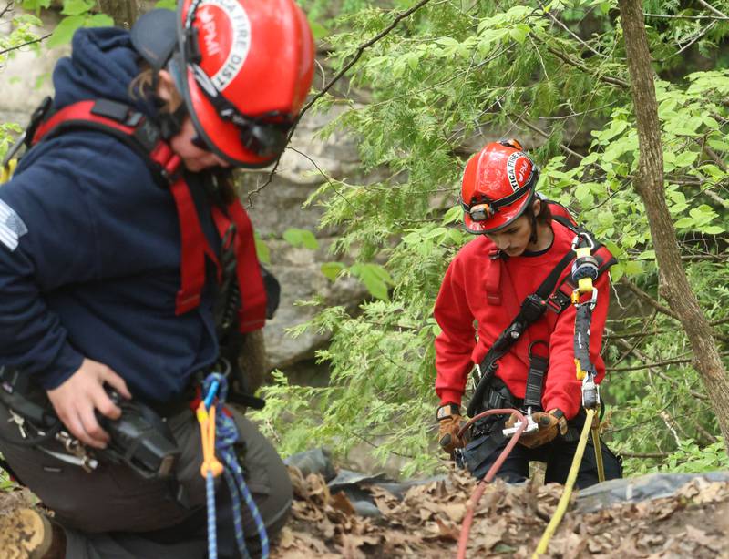 Utica firefighters Gabby McCabe assists firefighter John Klag as he makes a descent into Wildcat Canyon during rope rescue training on Saturday, May 2, 2026 at Starved Rock State Park.