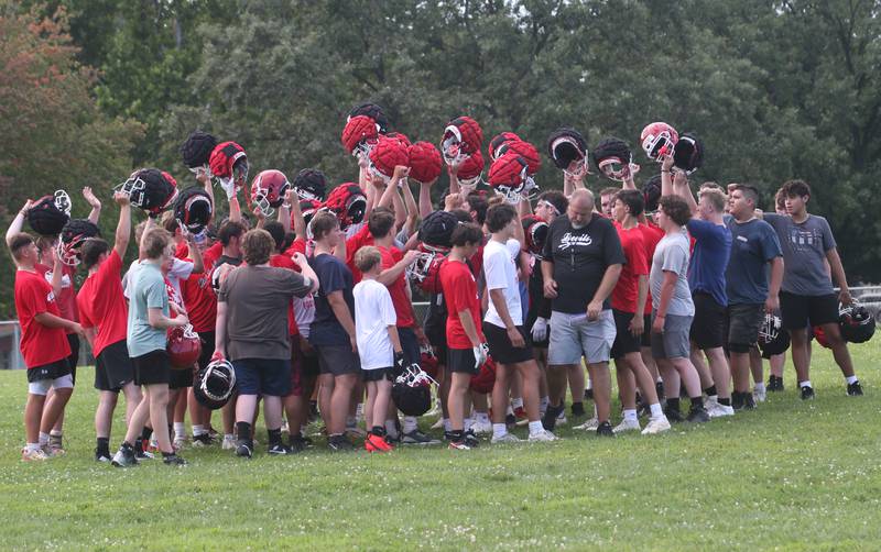Members of the Hall football team huddle during the first day of football practice on Monday, Aug. 11, 2025 at Hall High School.