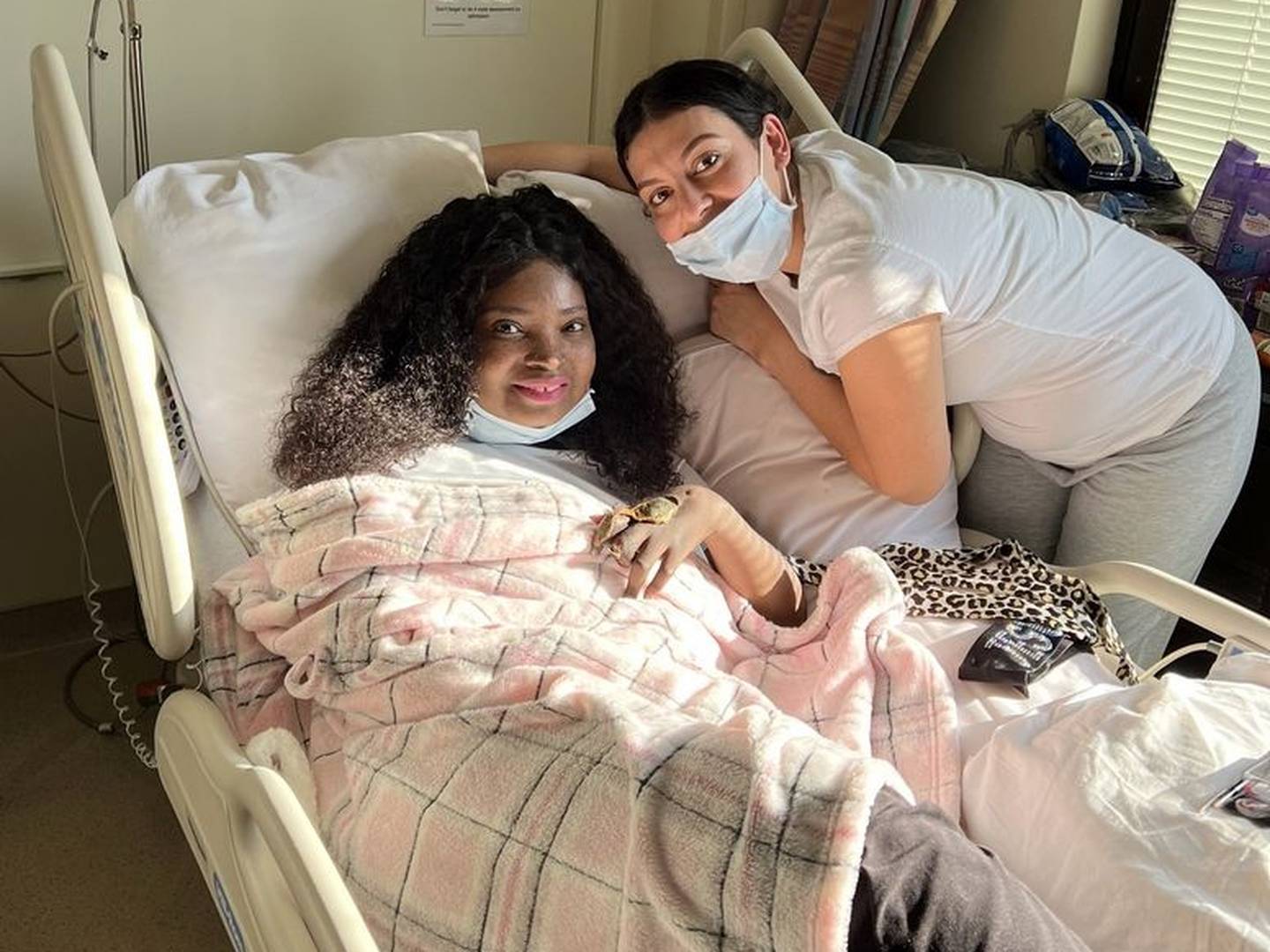 Shaquita Slaughter gets ready Thursday to leave Advocate Lutheran General Hospital with help from sister-in-law Isamar Barraza after months battling COVID-19.
