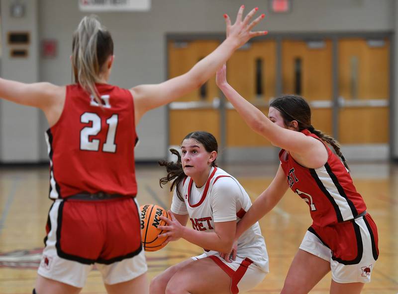 Benet’s Aria Mazza (middle) coils to shoot while double teamed by Marist during a game on January 8, 2025 at Benet Academy in Lisle.