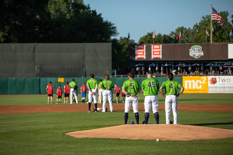 The Kane County Cougars stand for the National Anthem before a game against the Milwaukee Milkmen at Northwestern Medicine Field on Thursday, July 14, 2022.
