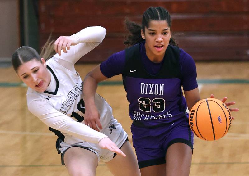 Dixon’s Ahmyrie McGowan and Kaneland's Kalie Brown collide as McGowan brings the ball up during their Class 3A sectional semifinal game Tuesday, Feb. 25, 2025, at Boylan Catholic High School in Rockford.