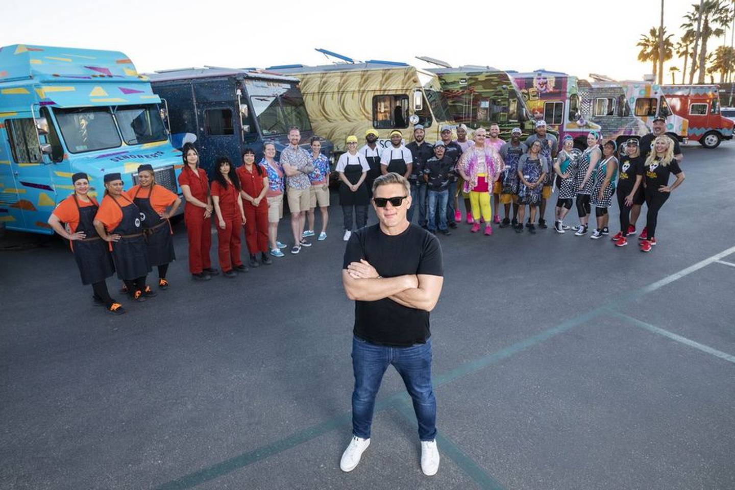 Host Tyler Florence of Food Network's "The Great Food Truck Race" poses with this year's contestants. The first episode of the season airs Sunday, June 5, 2022.