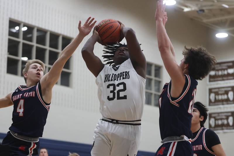Joliet Catholic’s Nakari McElrath battles for the shot against St. Viator.