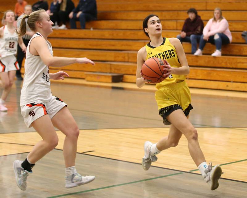 Putnam County's Ava Hatton runs past Roanoke-Benson's Lexi Weldon to score on a layup during the Tri-County Conference Tournament on Tuesday, Jan. 17, 2023 at Midland High School.