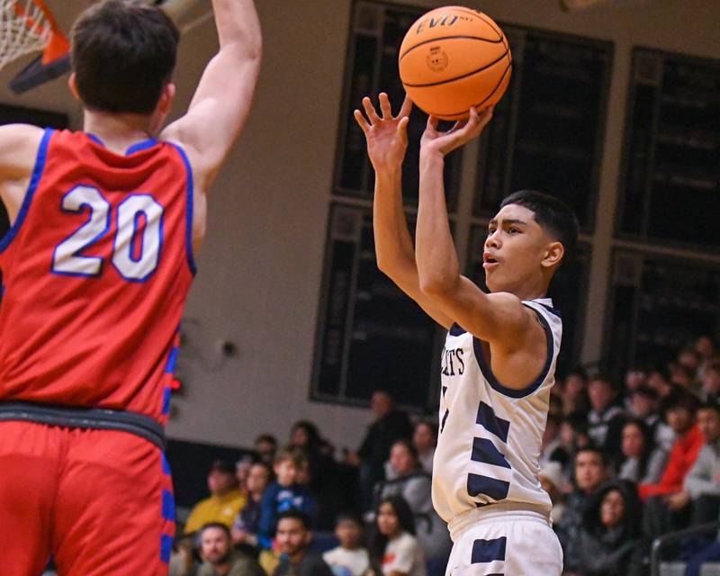 West Chicago's Marcus Brewell (1) makes a three-point basket during the game on Friday Jan. 3, 2025, while being defended by Glenbard South's Will Sieck (20) held at West Chicago High School.