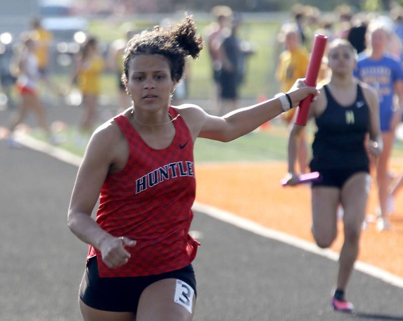 Huntley’s Ari Ford runs to the finish line as Huntley wins the 4 x 100 meter relay on Thursday, April 23, 2026, during the McHenry County Track and Field Meet at McCracken Field in McHenry.