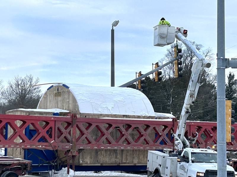 Advance crews raise wires and traffic signals at the state Route 64 intersection with Daysville Road, east of Oregon, on Monday, Dec. 8, 2025 as  one of the large turbines is transported to Constellation's Byron generating station.