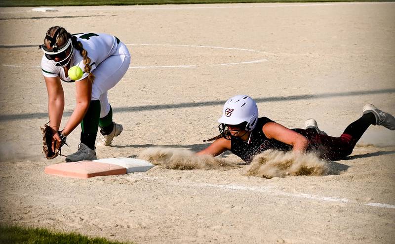 Rock Falls first baseman Abby Whiles can't handle a pickoff throw from the catcher while Richmond Burton's Hailey Holtz safely slides back to first. during Stillman sectional semifinal action in Davis Junction Tuesday.
