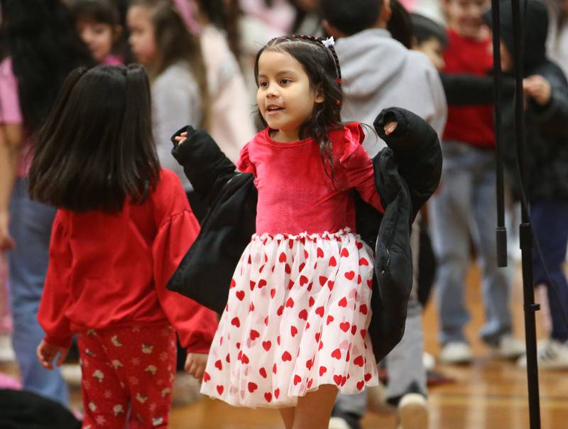 While wearing her Valentines Day dress, Arantza Colmenarez a student at DePue School, dances to music while listening to the NIU Steelband play on Friday, Feb. 14, 2025 at DePue School.