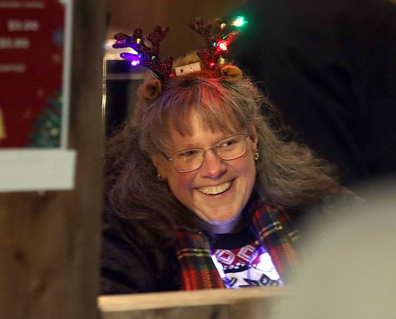 Michelle Trcka offers hot chocolate for people as part of holiday events Saturday, Dec. 7, 2024 in downtown Marengo.