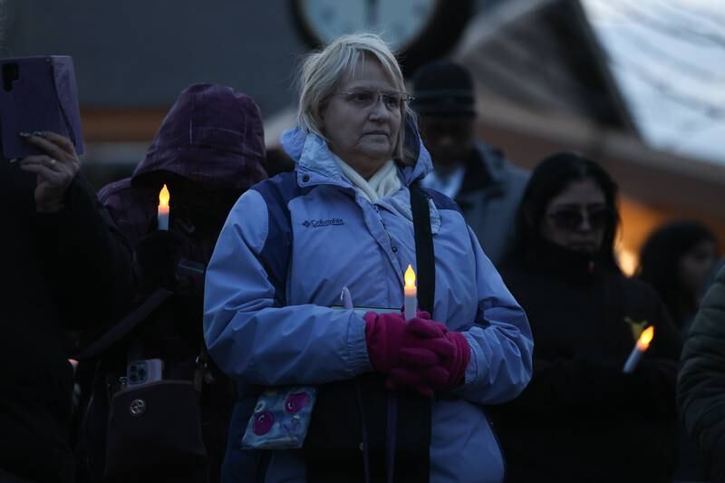 People stand somberly during the candlelight vigil for the victims of the March 5th shooting on Wednesday, March 8th, 2023 in Bolingbrook.