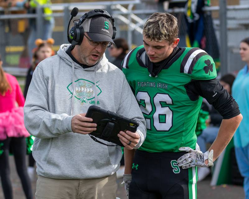 Seneca Assistant Coach, Levi Derber shows Matt Stach (26) play on tablet on Saturday, November 1, 2025 at Seneca High School in Seneca.
