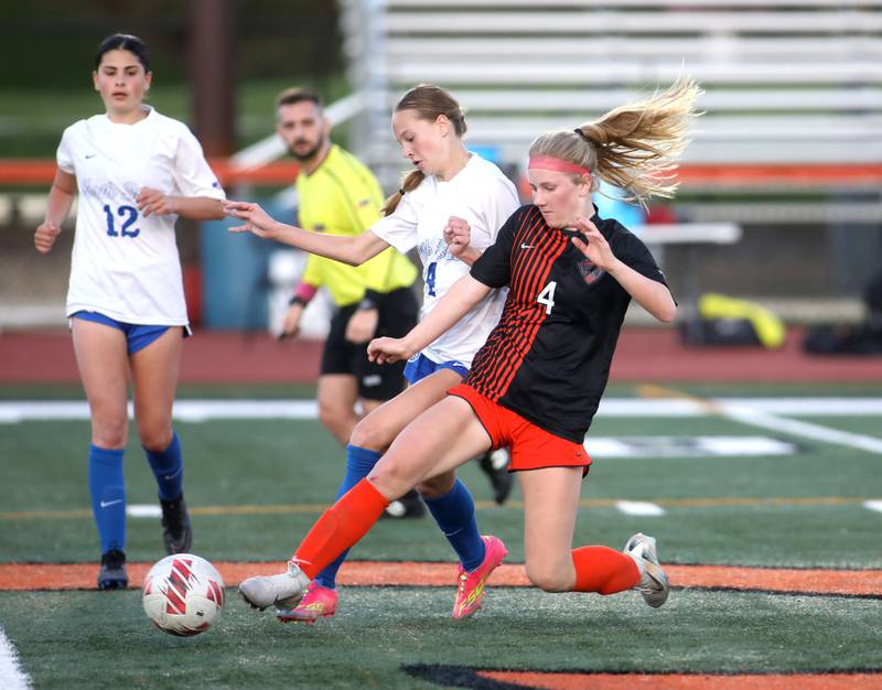 St. Charles North’s Kaitlyn Nudera (left) and St. Charles East's Presley Kannaka go after the ball during a Tri-Cities Soccer Night game on Tuesday, April 29, 2025 in St. Charles.