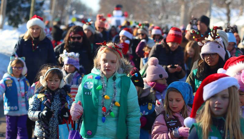 Girl Scouts march during the Merry Cary Christmas Parade in Cary on Sunday, Dec. 7, 2025 in Cary.