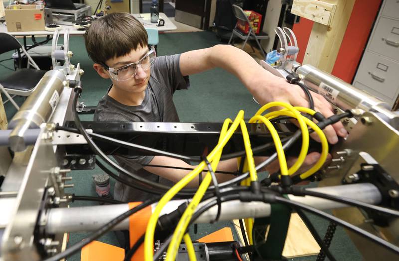 Blake Bollow, a freshman at DeKalb High School and part of the "Crowbotics" team, works on their robot Thursday, March 10, 2022, at Huntley Middle School in DeKalb. The team is preparing for a competition that begins in early April.