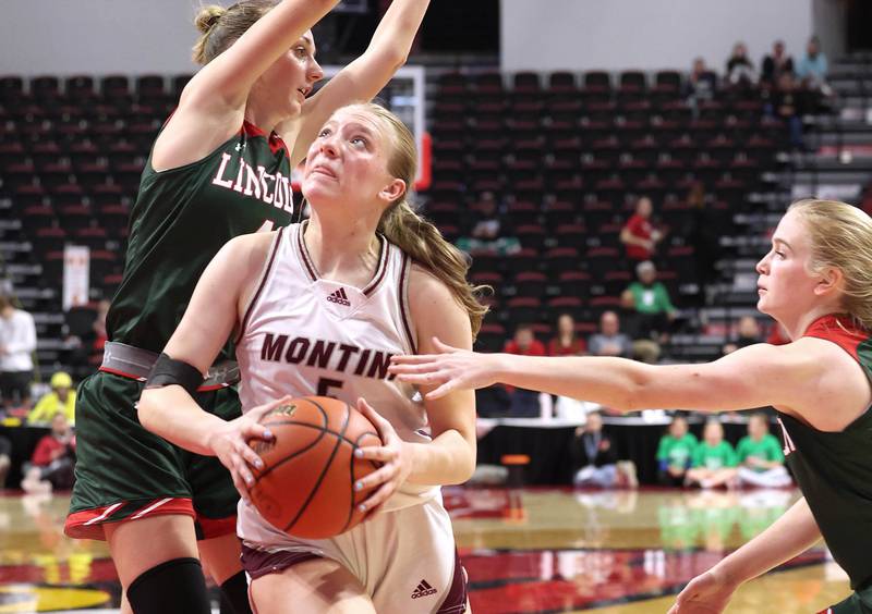 Montini's Victoria Matulevicius splits two Lincoln defenders on her way to the basket during their game Friday, March 1, 2024, in the IHSA Class 3A state semifinal at the CEFCU Arena at Illinois State University in Normal.