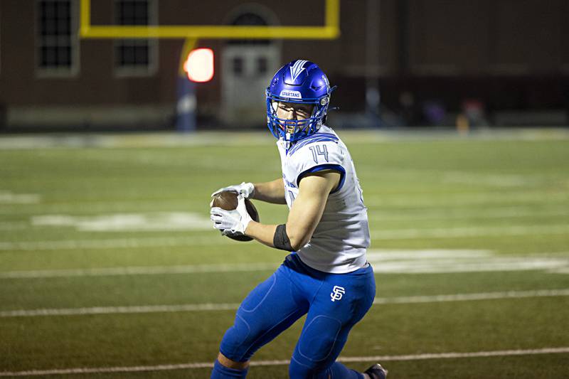 St. Francis’s Liam Kolinski turns upfield after a catch against Sterling Saturday, Nov. 4, 2023 in a class 5A playoff game in Sterling.