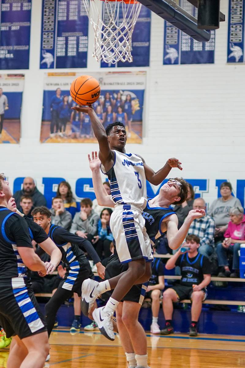 Newark’s Reggie Chapman (3) shoots the ball in the post against Hinckley-Big Rock's Marshall Ledbetter (33) during a basketball game at Newark High School on Tuesday, January 28, 2025.