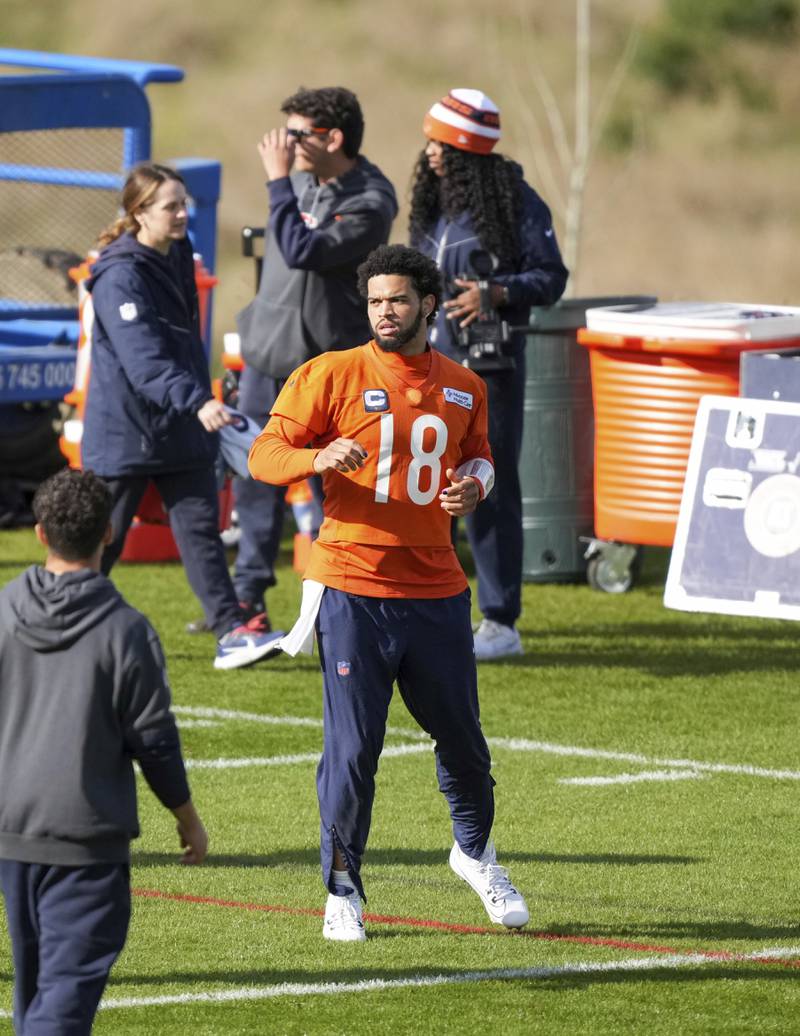 Chicago Bears quarterback Caleb Williams (18) stretches during a training session in Ware, England, Thursday, Oct. 10, 2024, ahead of the game between the Chicago Bears and the Jacksonville Jaguars at Tottenham Hotspur Stadium on Sunday. (AP Photo/Sean Ryan)