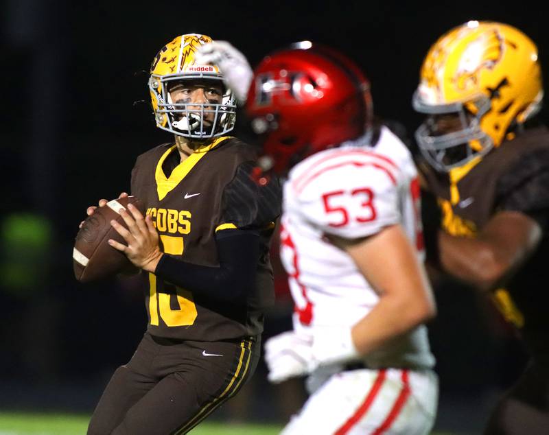 Jacobs’ Austin Stennett prepares to fire a late first-half touchdown pass to Carson Goehring against Huntley in varsity football at Jacobs High School in Algonquin on Friday, Sept. 26, 2025.