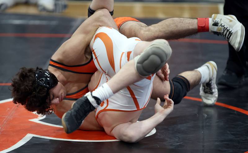 St. Charles East’s Tyler Guerra wrestles Wheaton Warrenville South’s Cooper Hollis at 138-pounds during the DuKane Conference Meet Saturday, Jan. 20, 2024 in St. Charles.