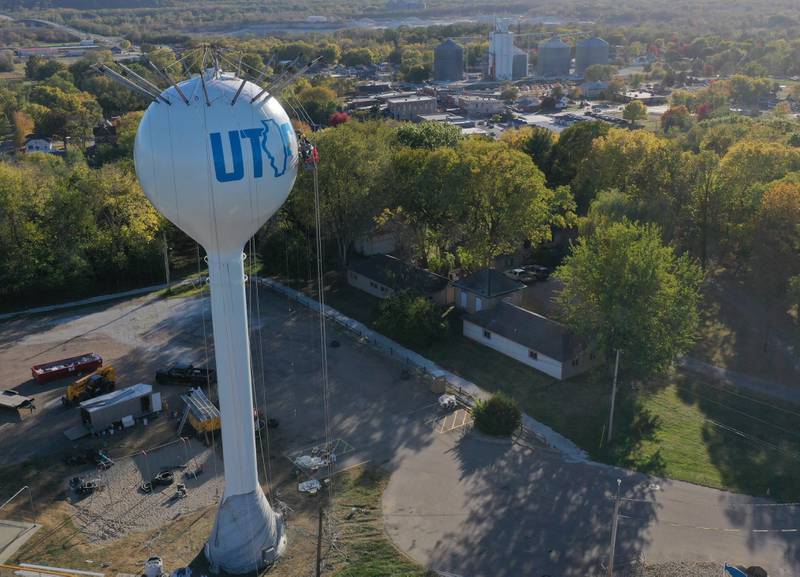 Crews paint the Utica water tower on Friday, Oct. 18, 2024 on top of Clarks Hill in Utica. The Village gave the approval to paint the tower and also conduct repairs inside and out. A Bald Eagle and the State of Illinois is featured on the tower.