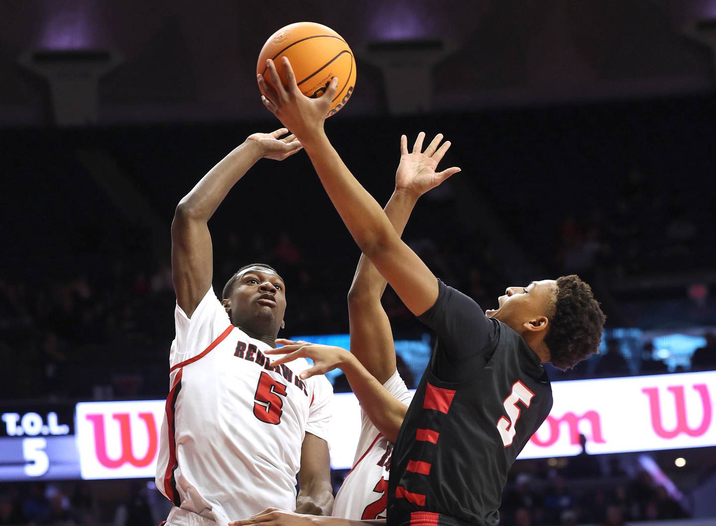 Benet's Perry Tchiegne goes to the basket against Marist's Stephen Brown Saturday, March 14, 2026, during their IHSA Class 4A state championship game in the State Farm Center at the University of Illinois in Champaign.