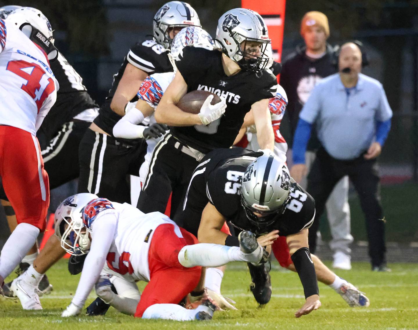 Kaneland's Carter Grabowski follows the blocking of Jackson Valentini through the Lakes defensive line Saturday, Nov. 1, 2025, during their first round playoff game at Kaneland High School in Maple Park.