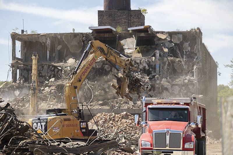 A truck waits to haul away debris Wednesday, Aug. 21, 2024, from the Micro building demolition site in Rock Falls.