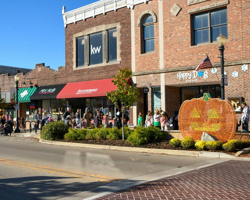 Participants paint windows on Saturday Oct. 26, 2024, during the Halloween event held in downtown Downers Grove.