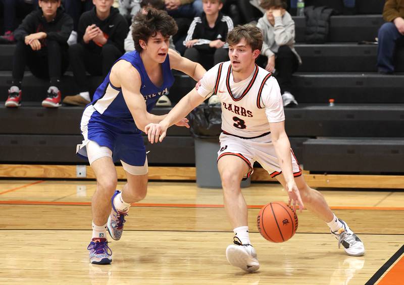 DeKalb’s Brayson Barnhardt drives by Geneva’s Luke Matan Thursday Dec. 28, 2023, during their second round game in the 96th Chuck Dayton Classic boys basketball tournament at DeKalb High School.
