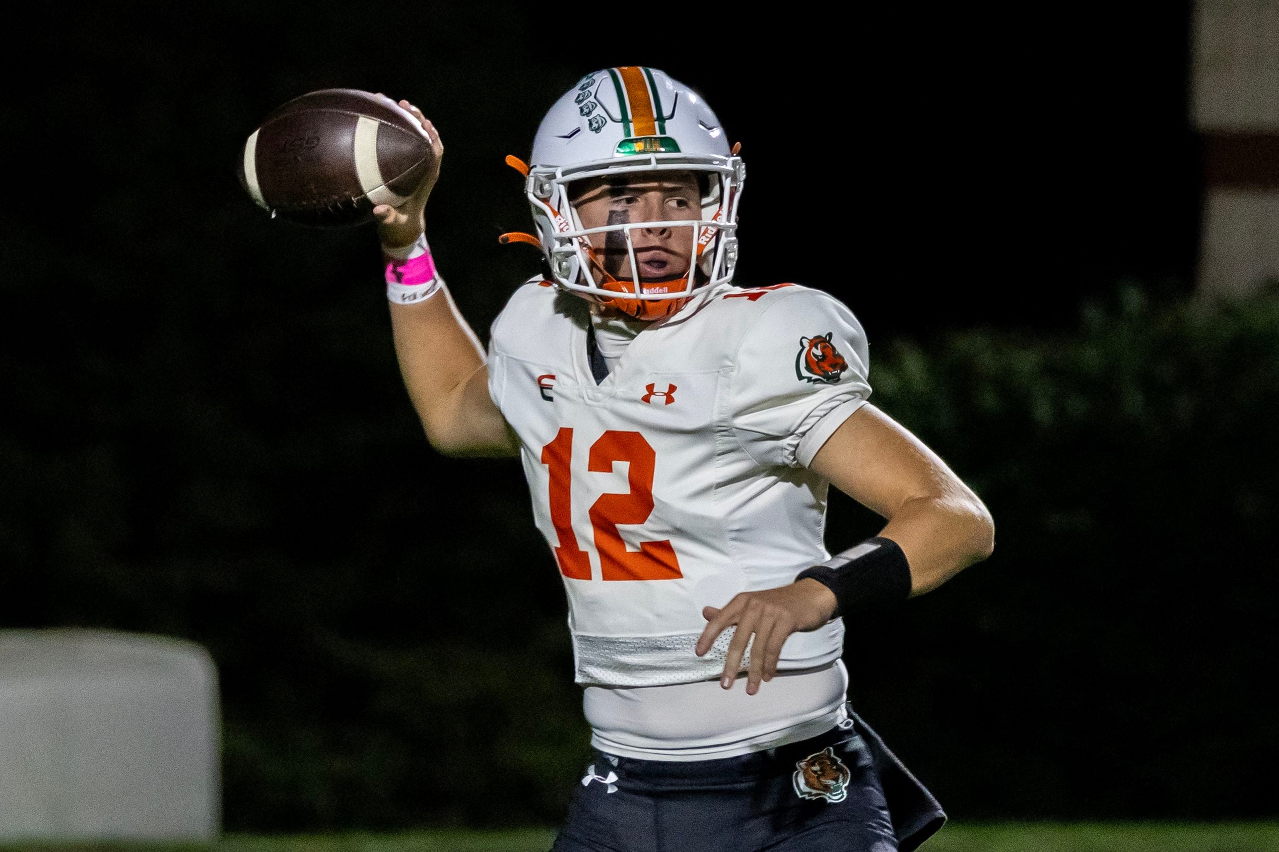 Plainfield East's Brady Cloherty looks for an open teammate during a varsity football game against Joliet West at Joliet West on Oct. 10, 2025.