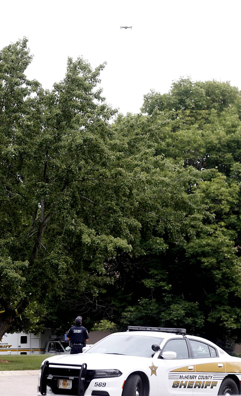 A drone flies overhead as officers from the McHenry County Sheriff and other departments investigate a domestic incident in which four people were killed on Wednesday Aug. 9, 2023, in the 5800 block of Wild Plum Road in unincorporated Crystal Lake. Police later said they were family members.