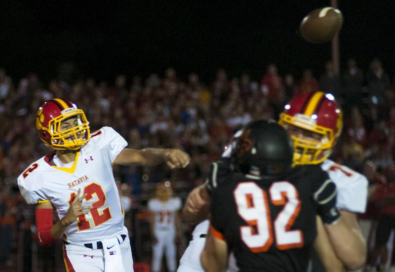Batavia High School's quarterback Evan Acosta throws the ball during the St. Charles East vs. Batavia game Friday at East High School.