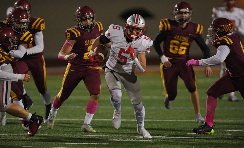 Palatine’s Thomas Coroneos runs against Schaumburg in a football game in Schaumburg on Friday, October 14, 2022.