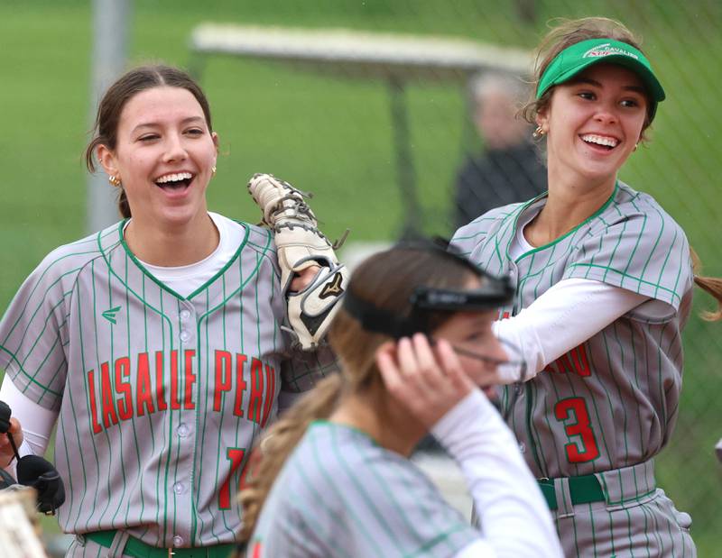 LaSalle-Peru's Brianna Ruppert (left) celebrates after making a good catch with teammate Dagny Greer Thursday, April 30, 2026, during their game at Sycamore High School.