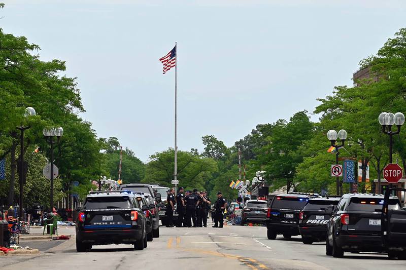 Police from several local municipalities including the Illinois State Police search downtown Highland Park after the mass shooting at the Fourth of July parade Monday, July 4, 2022 in Chicago. (Tyler Pasciak LaRiviere/Chicago Sun-Times via AP)