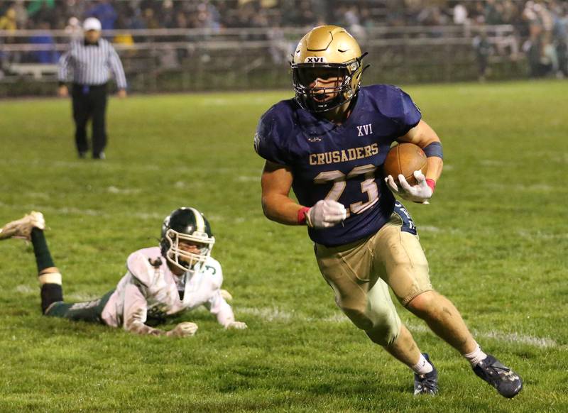 Marquette's Pete McGrath runs the ball up the field as St. Bede's Hunter Savage misses the tackle on Friday, Oct. 13, 2023 at Gould Stadium.