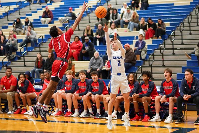 Geneva’s Gabe Jensen (2) shoots a three pointer against  West Aurora's Travis Brown jr (1) during a MLK Day of Hoops basketball game at Geneva High School on Monday, Jan. 20, 2025.