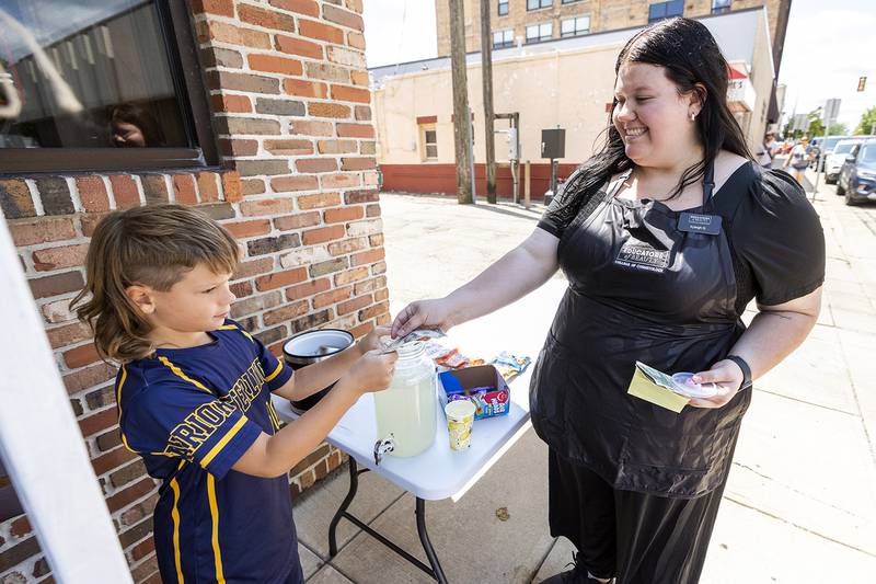 Kyleigh Glazier supports little brother Liam Glazier, 9, on Friday, Aug. 2, 2024, as the plucky entrepreneur sells lemonade and sweets during Sterling’s Hot Dog Day.