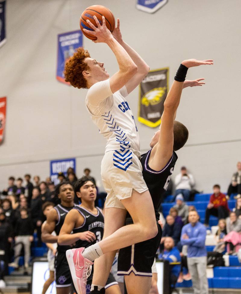 Burlington guard Patrick Shell, left,  goes up for a layup during a game against Hampshire High School at Burlington Central High School on Friday, Dec. 22, 2023.