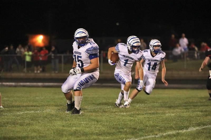 Princeton's Casey Etheridge gets blocks from Payne Miller (75) and Will Lott (14) for a run at Orion Friday night. The Tigers will host Sterling this week.